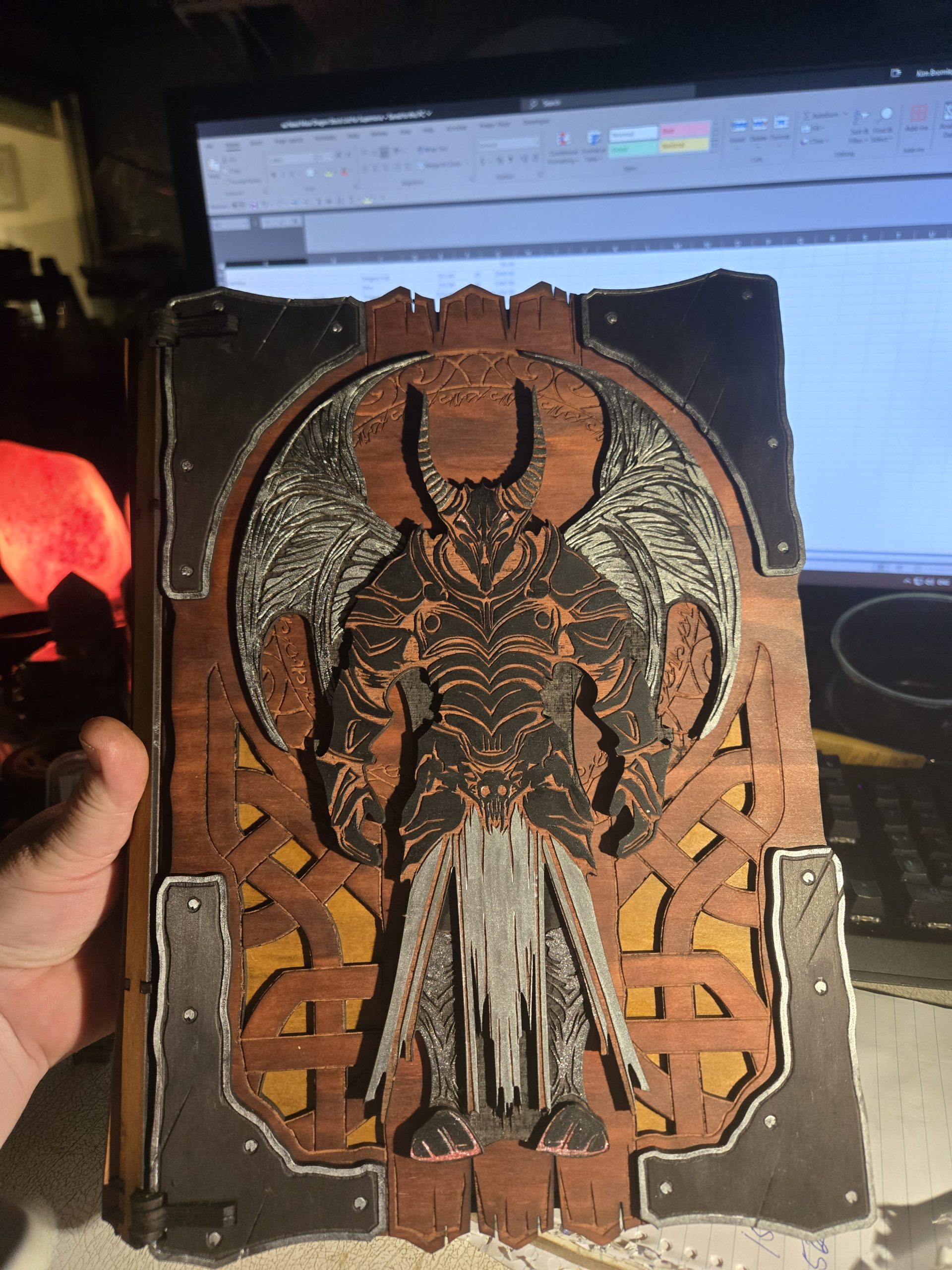 Large handcrafted wooden book box with a red and black finish, featuring an engraved guardian design on the cover.