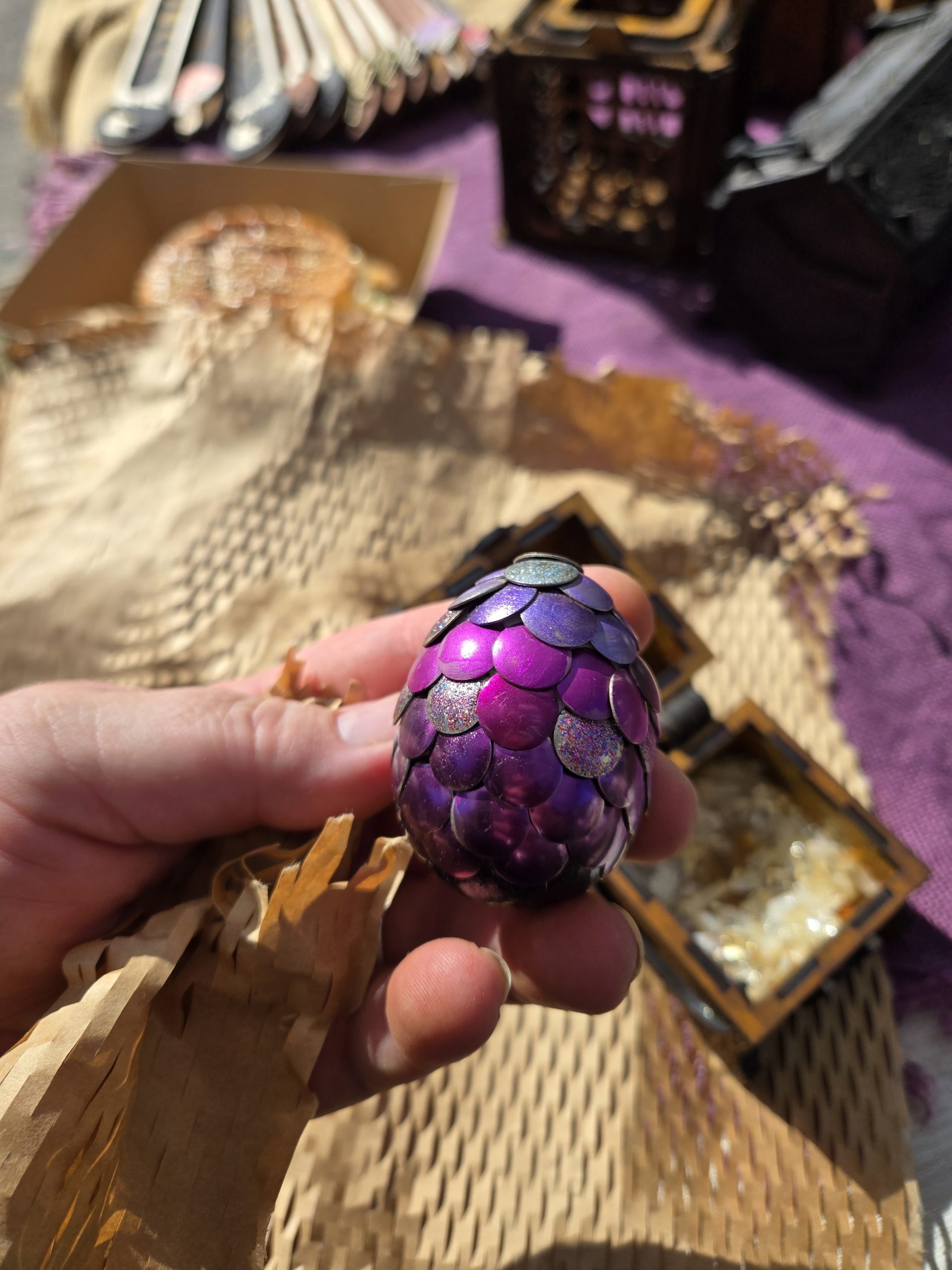 Handmade purple dragon egg with scale-like texture, inspired by fantasy designs and displayed as a decorative keepsake.