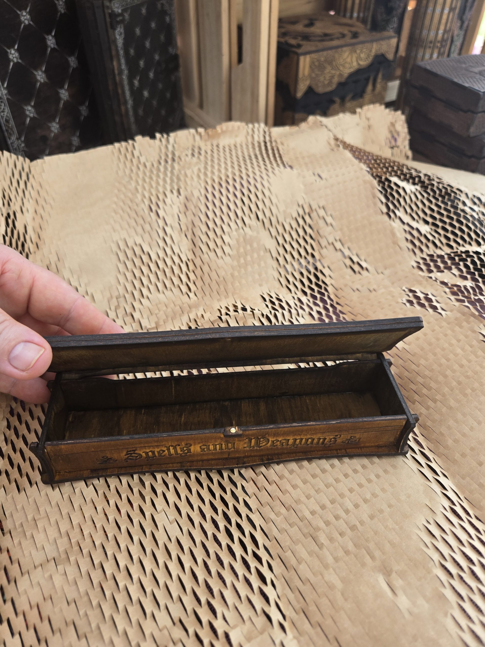 Small wooden dice box shown without internal insert, demonstrating removable storage options for dice or other items.
