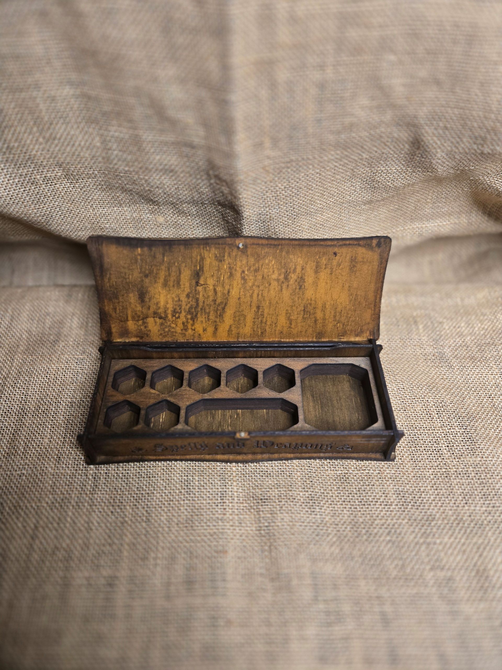 Wooden dragon eye box featuring engraved dragon scales and contrasting details, designed as a fantasy storage box for small items.