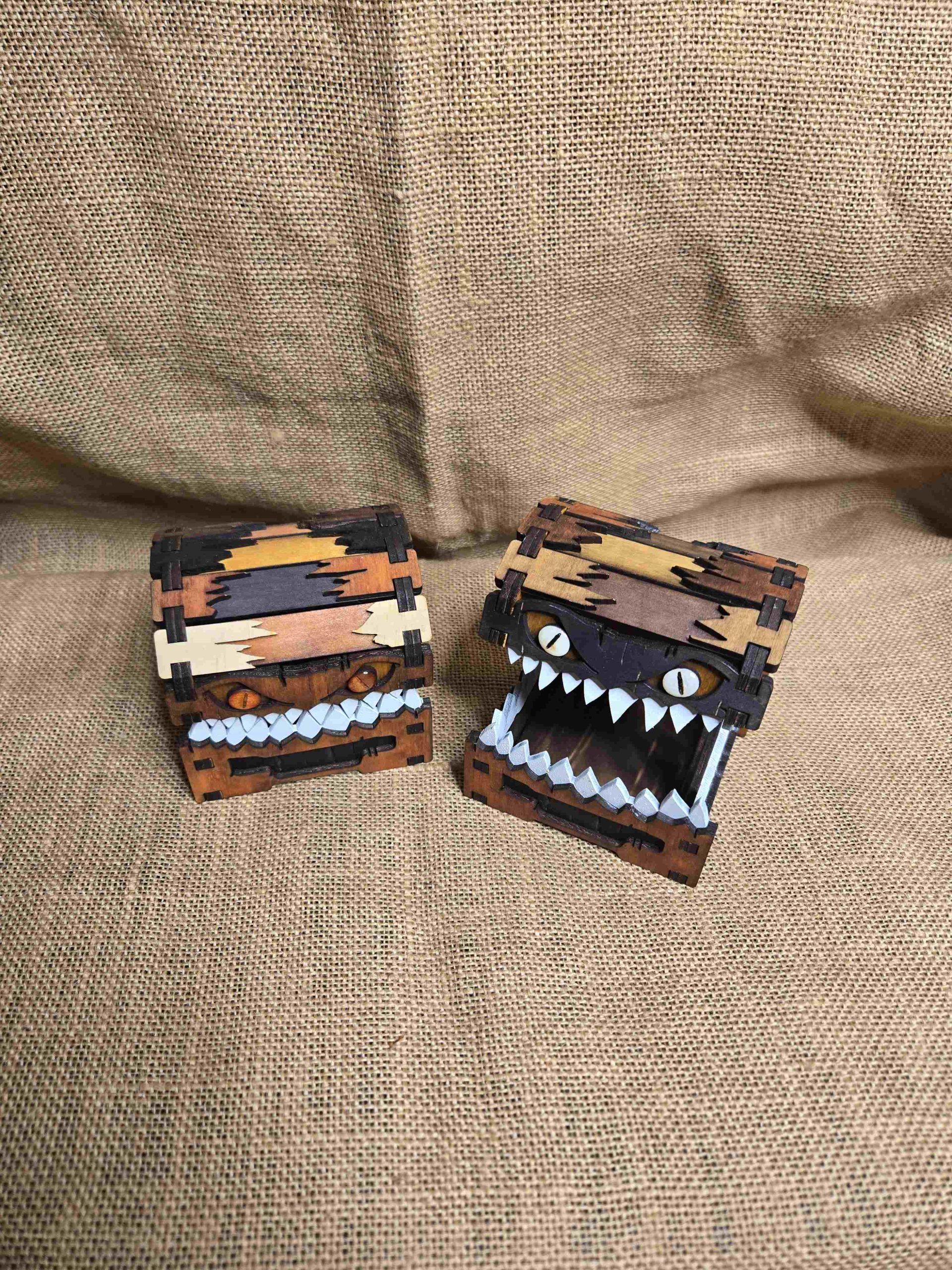 Two small handcrafted wooden mimic chests, shown open and closed, inspired by fantasy creatures.