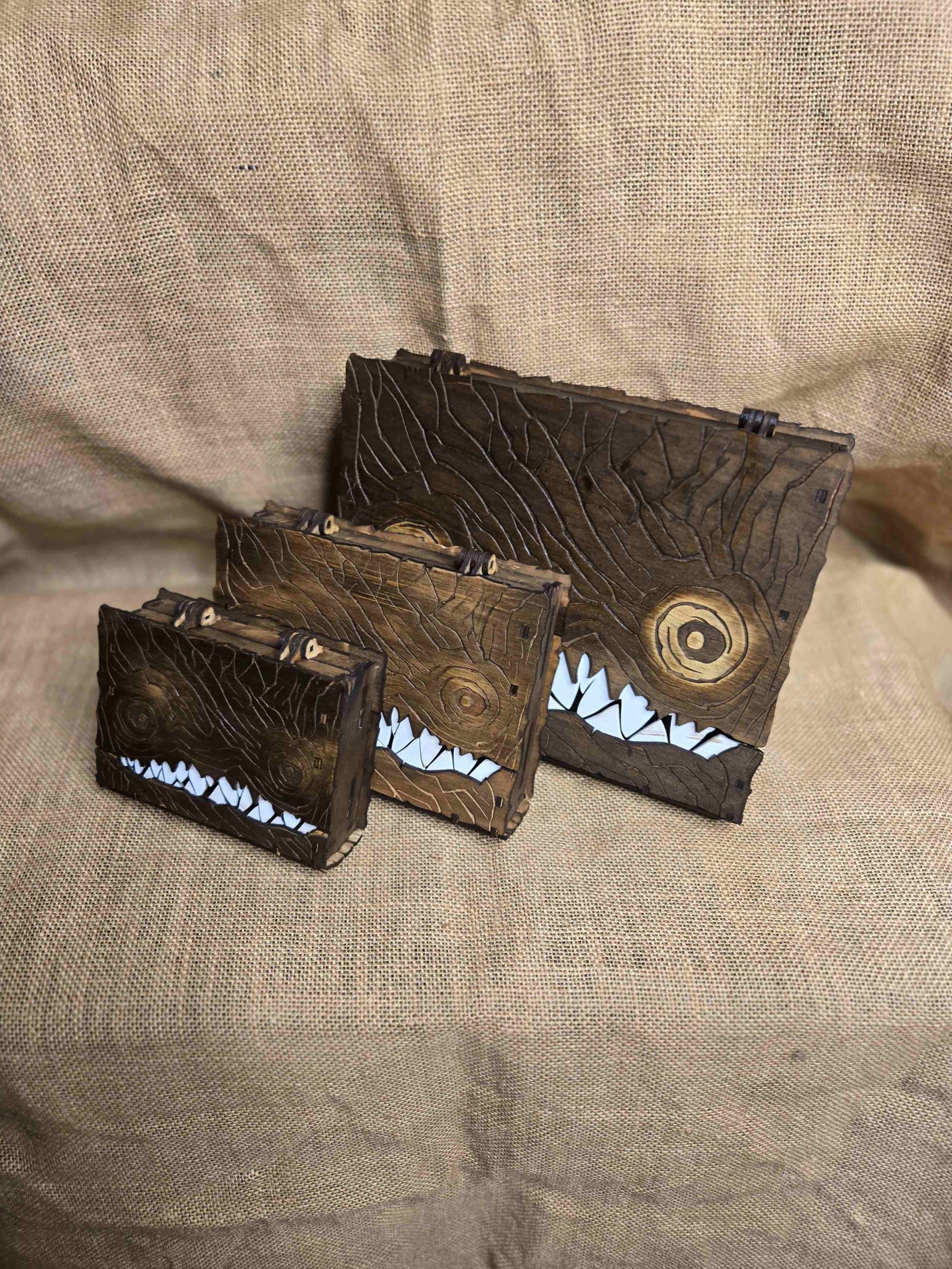 Handcrafted wooden monster book boxes in A5, A6 and A7 sizes, designed for fantasy storage and tabletop gaming accessories.
