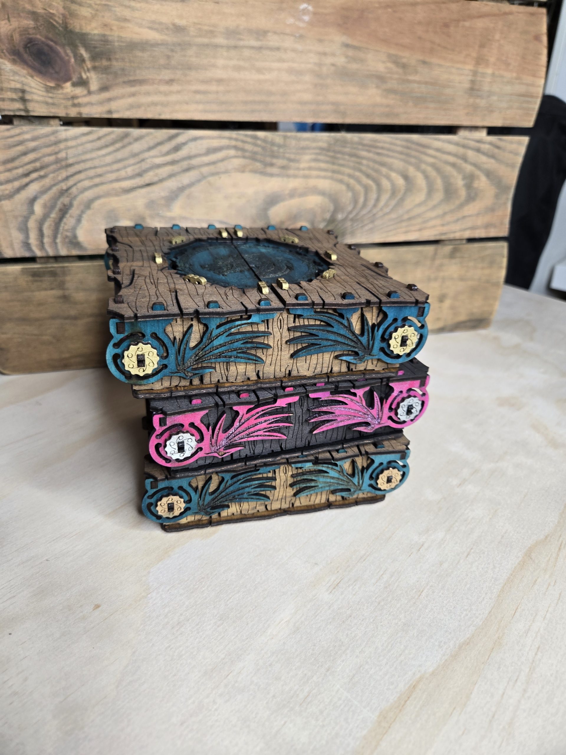 Stack of handcrafted wooden two-door dragon boxes with woodgrain finish, featuring a central dragon design and wing details on the sides.