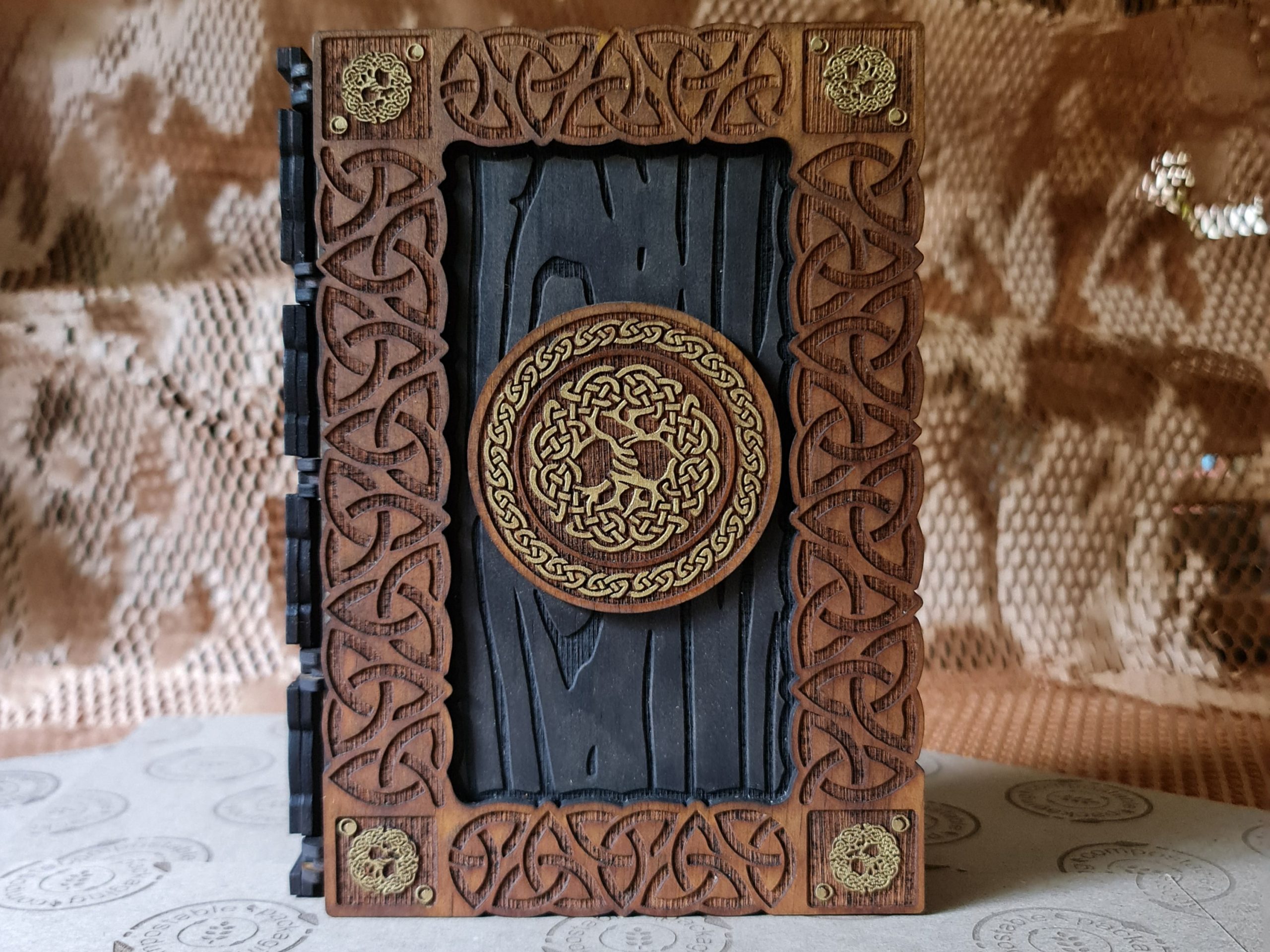 Viking-inspired wooden book box that opens fully and can be used as a dice tray, featuring high sides to contain dice.