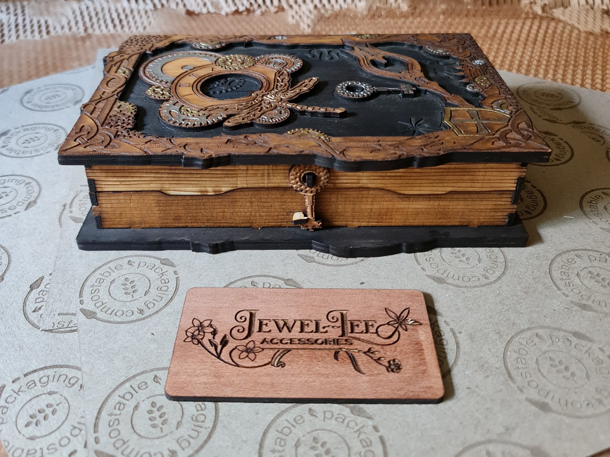 Alternate view of a steampunk-style wooden book box showing interior storage and engraved mechanical details.