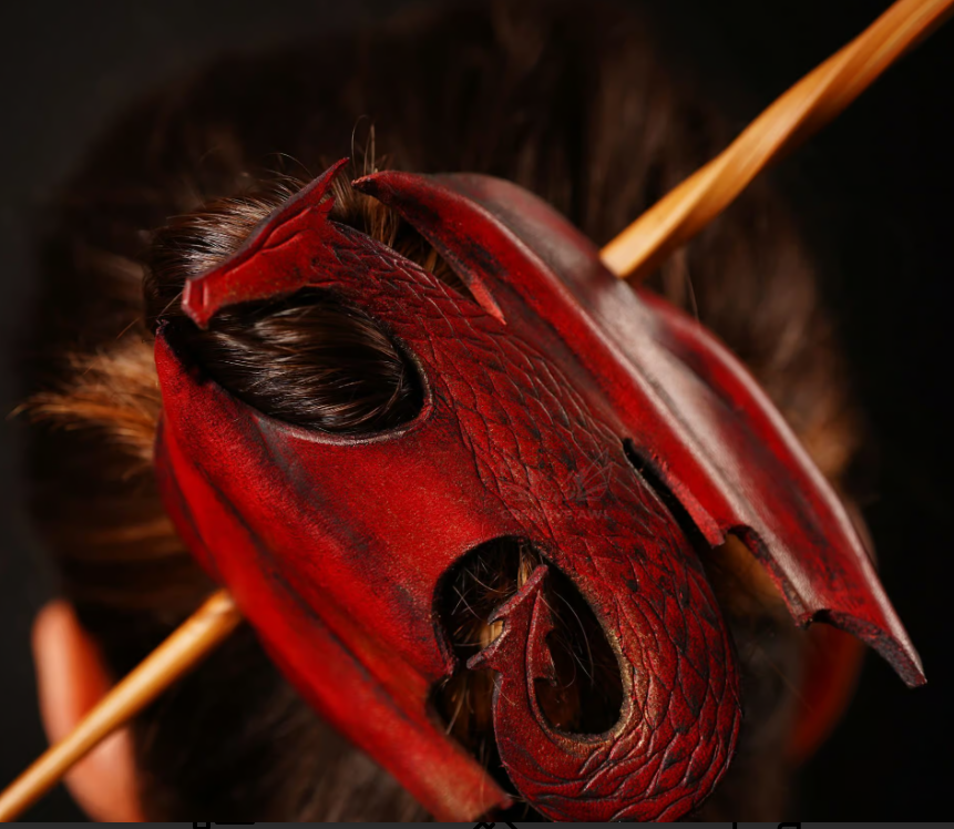 Handcrafted fantasy accessories including pendants, bags, hair accessories and earrings, featuring a red leather dragon hair accessory.