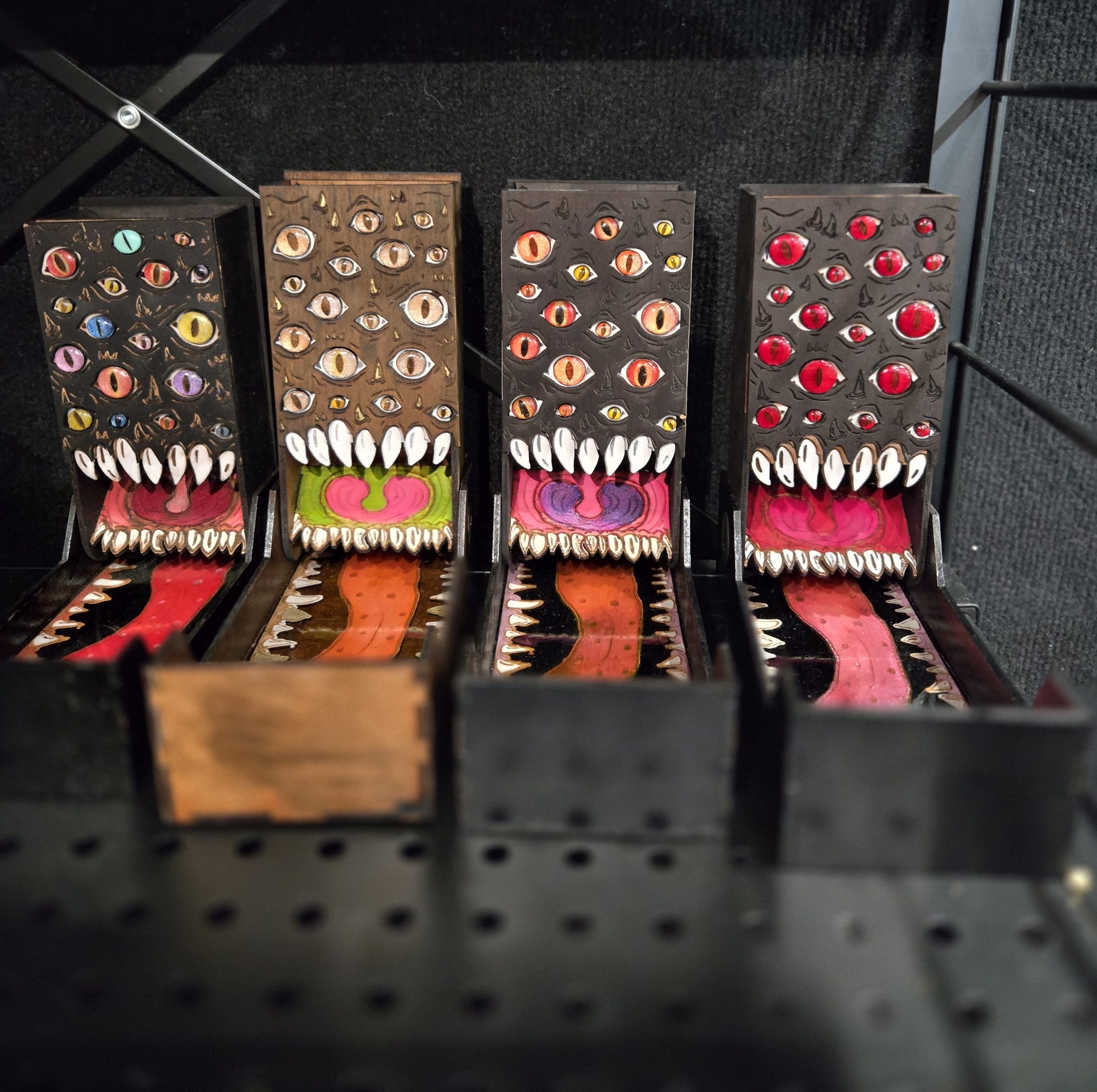 Limited edition wooden fantasy items including folding mimic dice towers with coloured details, dice displays and special tabletop gaming pieces.